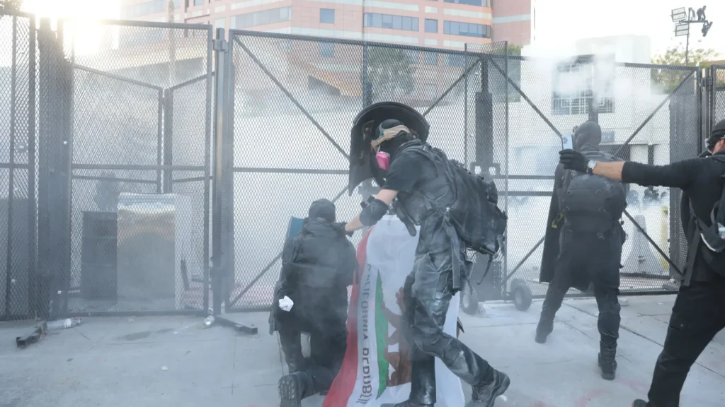 'No Kings' rallies across the US turn into chaos, leading to at least 13 arrests, tear gas and 'tactical alert' declared in LA