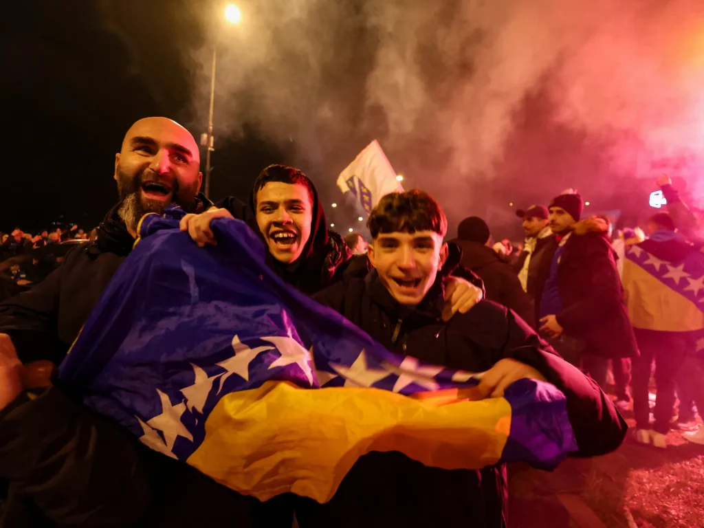 Bosnia fans celebrate as the team qualifies for the World Cup by defeating Italy. game