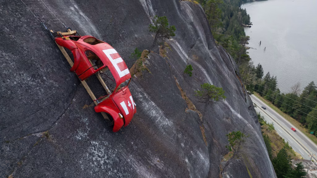 Car circle hung on rock above British Columbia highway in apparent joke