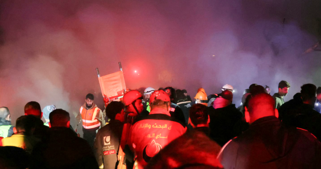 Emergency workers search for victims of Israeli air strikes on Beirut. Hezbollah