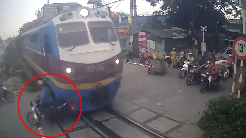 The horrifying moment the distracted biker crossed the tracks as the train was speeding towards him was a heartbreaking tragedy