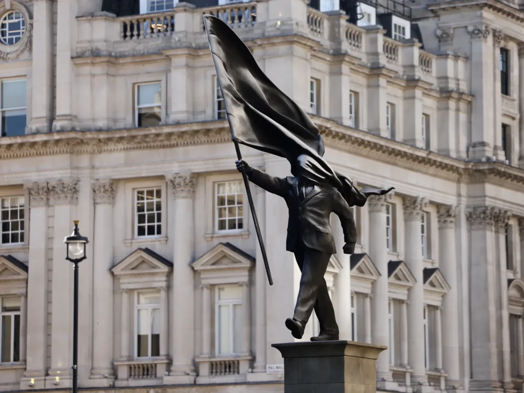 Banksy's new sculpture shows a politician being blinded by his own flag. art and culture