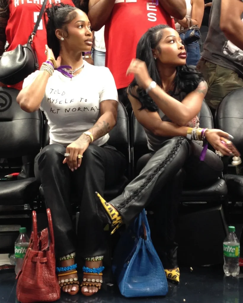 Des Dior in Vintage Giuseppe Zanotti Shell Heels and Jayda Cheeves in Baleniaga Caution Tape Pumps at Atlanta Dream WNBA Game