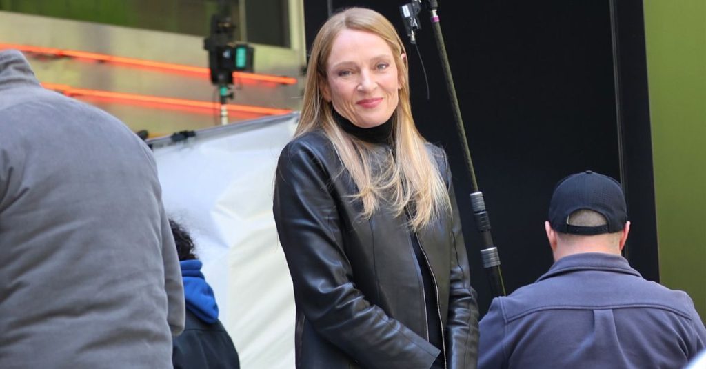 Uma Thurman wears perfectly styled jeans with the best white trainers