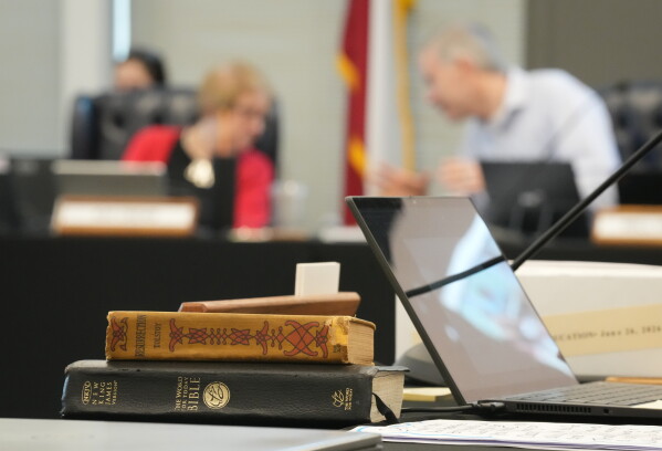 A Bible and Resurrection by Leo Tolstoy sit on the desk of State Board of Education member LJ Francis during a meeting on proposed social studies standards at the Barbara Jordan Building in Austin on Monday, June 22, 2026. (Jay Janner/Austin American-Statesman via AP)