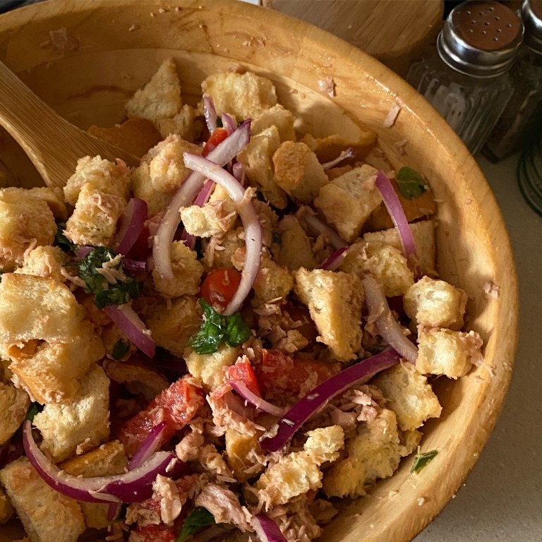 a large bowl with tuna panzanella salad in it