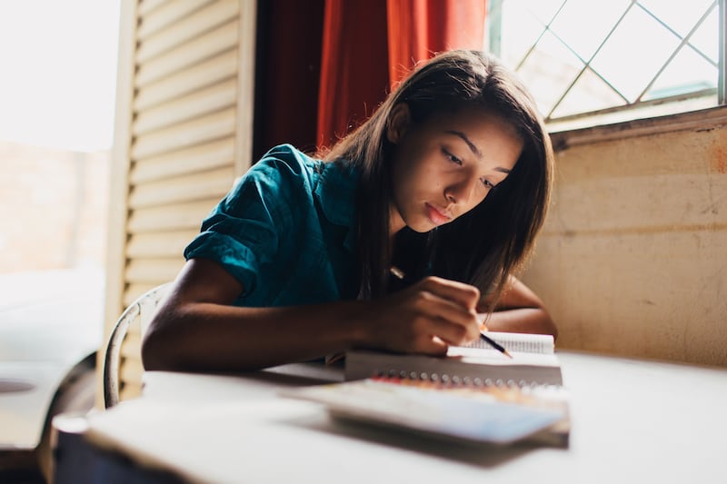 A young woman in Brazil reads and marks her scriptures.
