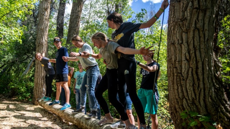 Latter-day Saint young women and young men participate in an outdoor activity.